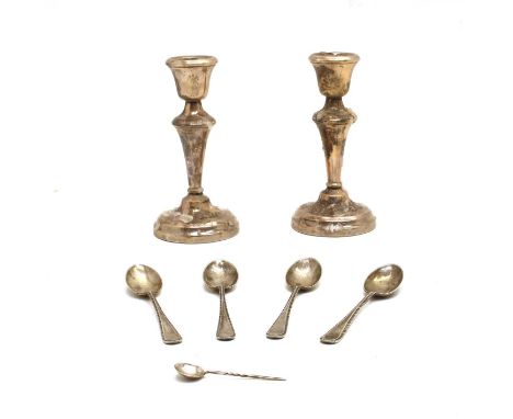 A pair of silver candlesticks with knopped tapering stem, Birmingham 1956, together with a set of four silver teaspoons, Shef