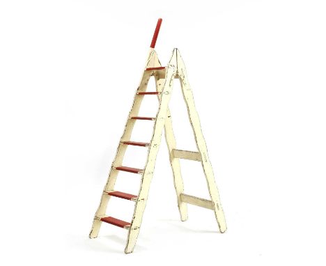 An early 20th Century Circus style painted ladder, having shaped supports and original red painted steps, 100cm wide, 174cm h