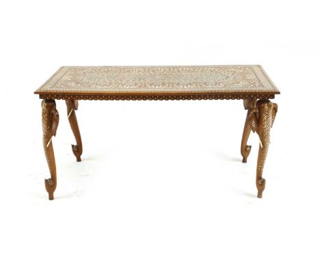 An Anglo Indian coffee table, profusely inlaid with designs with elephant head supports, 103cm long, 511cm deep, 515.cm high