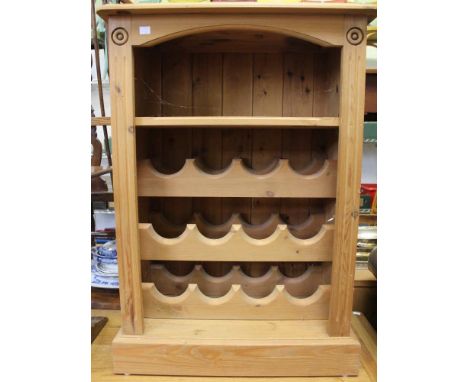 A pine open cupboard with shelf and wine racks below