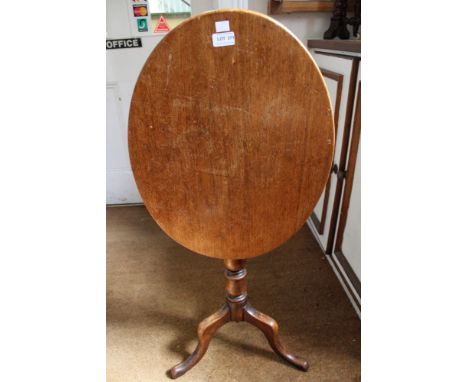 A 19th century mahogany oval snap top wine table, raised on turned stem with tripod supports