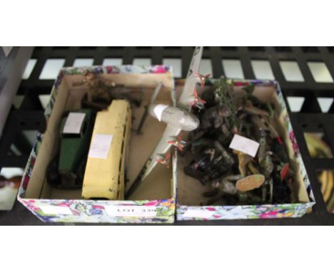 A small box containing a selection of vintage metal soldiers, together with metal car, plane, and bus&nbsp;