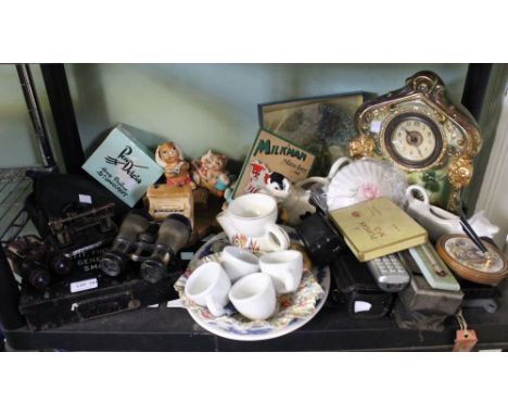 A shelf of useful and collectible items to include Pendelfin figures, binoculars, clock etc