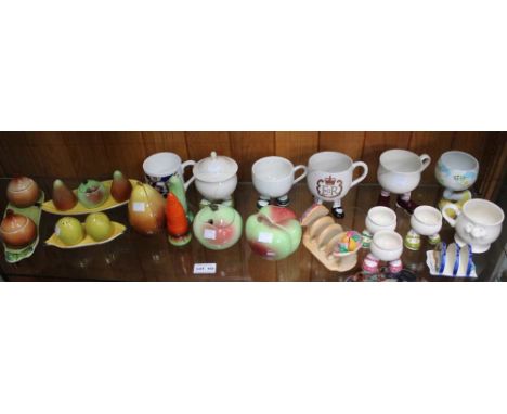 A shelf of Carlton Ware condiment sets, mugs on legs etc