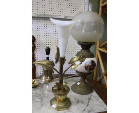 A vintage brass and ceramic oil lamp with a brass and glass centre piece