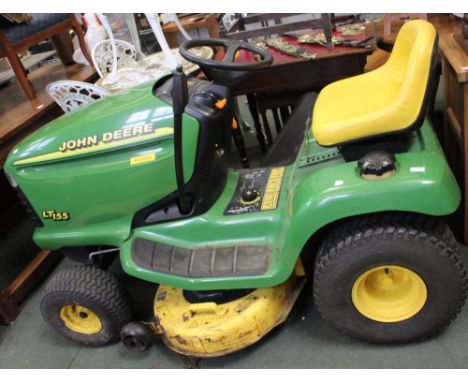 A John Deere LT155 ride-on tractor lawn mower in need of repair, no battery, no key &amp; flat tyre