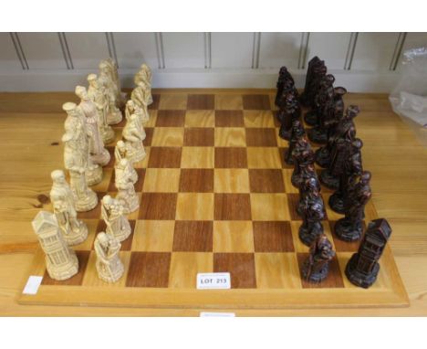 A wooden chessboard together with resin set of chess pieces