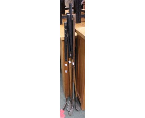 A selection of vintage golf clubs with hickory shaft