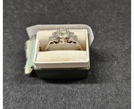 DIAMOND SOLITAIRE LADIES RING ON PLATINUM SHANK WITH DIAMOND CHIP STEPPED SHOULDERS     
