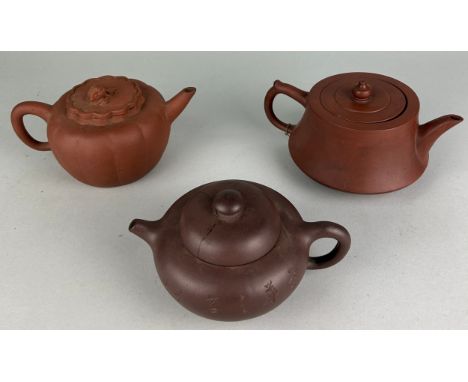 A COLLECTION OF THREE CHINESE YIXING CLAY TEAPOTS (3) One with calligraphy to front, but damaged lid. Two with seal marks to 