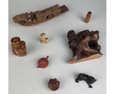 A COLLECTION OF SMALL CHINESE AND JAPANESE NETSUKES, TEA POT, VASE, BOAT, CARVED LION HEAD,And a small ceramic blackamoor hol