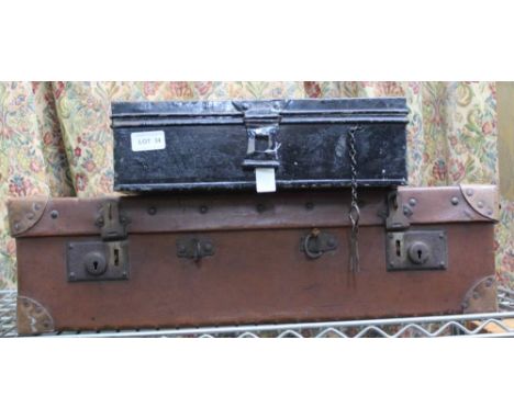 A BLACK FINISHED STORAGE TIN TRUNK together with a brown leather suitcase 