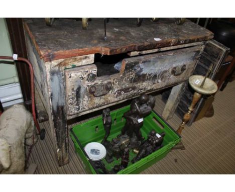 A MANTEL SHELF WITH CARVED FIRE SURROUND together with a well used softwood work bench 