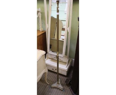 A BRASS COLUMN STANDARD LIGHT on trefoil base with paw feet 