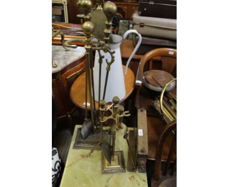 A WORK TOP MANGLE together with a series of fireside tools, and a large tin jug 