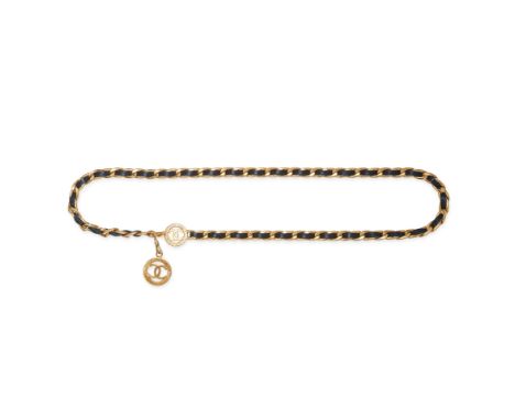 NO RESERVE - CHANEL, A VINTAGE NAVY LEATHER BELT comprising a chain link belt intertwined with navy leather, suspending a CC 