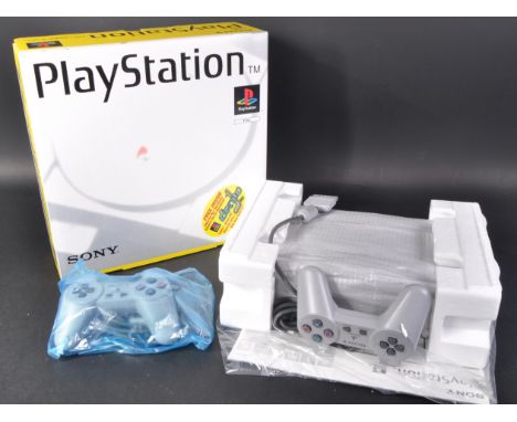 Retro Gaming - an original grey boxed Sony Playstation One PS1 video games console model no. SCPH-5502 and an official first 