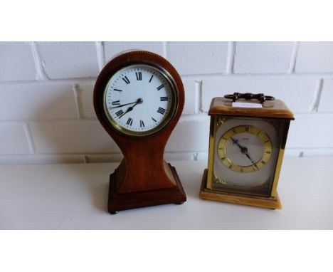 An Edwardian mahogany and inlaid dome top mantle clock, the circular enamel dial with Roman numerals, raised on bun feet toge