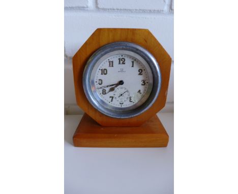 An Omega desk clock, the circular enamel dial with Arabic numerals and subsidiary seconds dial in a hexagonal stained wood fr