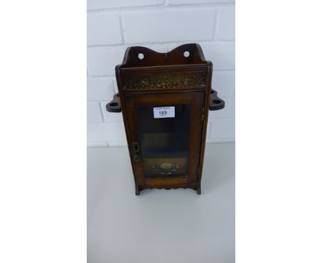 Mahogany smoker’s cabinet, with a galleried frieze to top above a glazed door with a drawer to the interior, flanked by pipe 