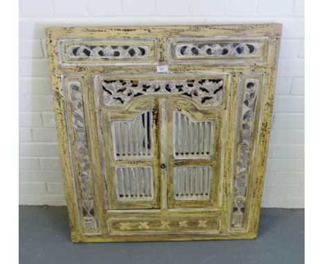 A contemporary Eastern style wall mirror with fretwork panel doors opening to reveal the mirrored glass plate, 81 x 90cm  