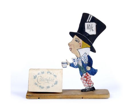 A RARE 1920'S TALFORD TOYS TYPE PAINTED PLYWOOD CALENDAR STAND, modelled as the Mad Hatter standing beside a paper calendar (