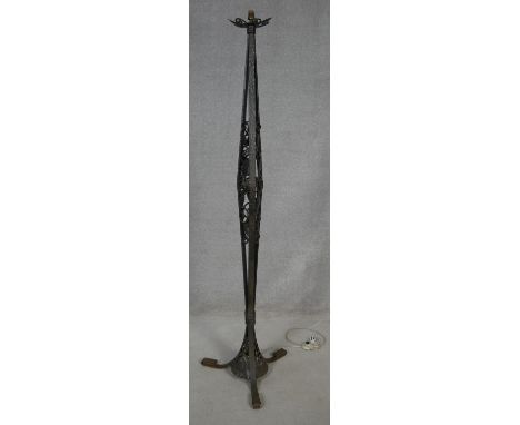 A vintage Art Nouveau style hammered metal standard lamp with pierced scrolling foliate decoration on swept tripod base. H.17