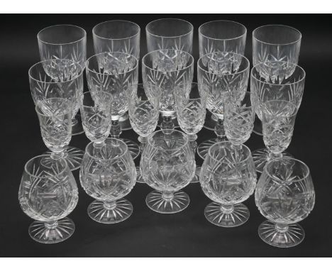 A collection of twenty one cut crystal glasses. Including ten foliate design wine glasses, five cognac glasses and six cordia
