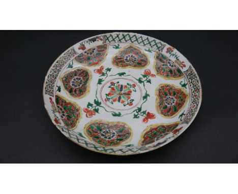 A Kangxi style Chinese Famille Rose porcelain hand glazed plate with stylized floral and foliate design. Fan mark to base. D.