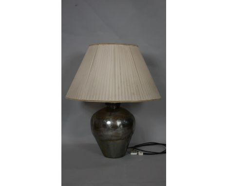 A vintage hammered metal table lamp of bulbous form with silk pleated shade. H.73cm (Including shade) 