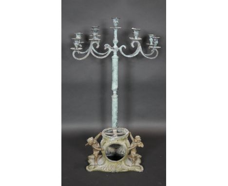 A metal table candelabra with four scrolling branches each with two sconces and a central sconce along with a 19th century gi