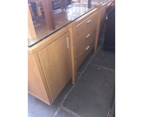 A modern light oak and glass top sideboard 