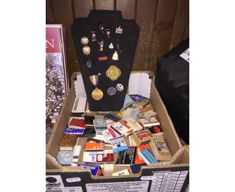 A collection of various enamel badges, including Robertson's jam, and matchbox covers 