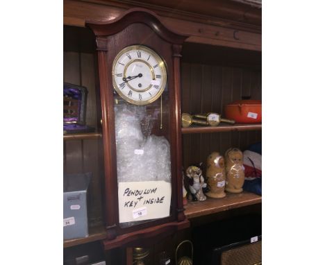 A Blandford wall clock with pendulum and key. 