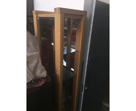 A modern light oak and glass tall display cabinet 