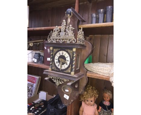 A vintage Nu Elck Syn Sin Dutch wall clock with weights and pendulum. 