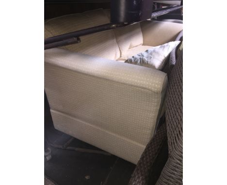 A Marks & Spencers cream cloth three seater settee, matching armchair and pouffe Condition:- General wear through use, Arms s