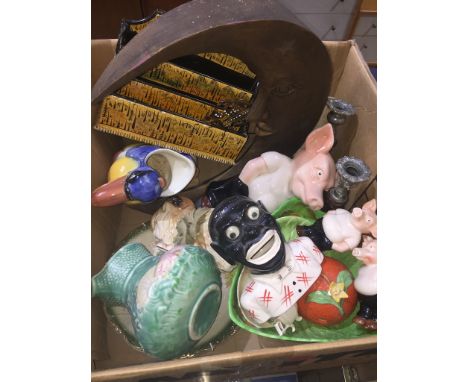 A box of misc. to include bird jug, ceramic money bank, pig ornaments, pair of candlesticks and a wooden moon. 