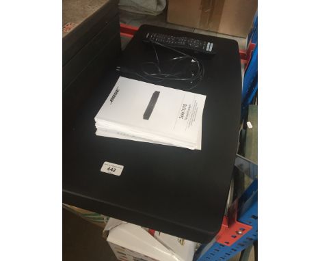 A Bose Solo 15/10 TV sound system with remote, manual, etc. 