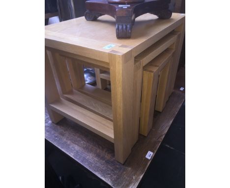 A modern light oak nest of three tables 
