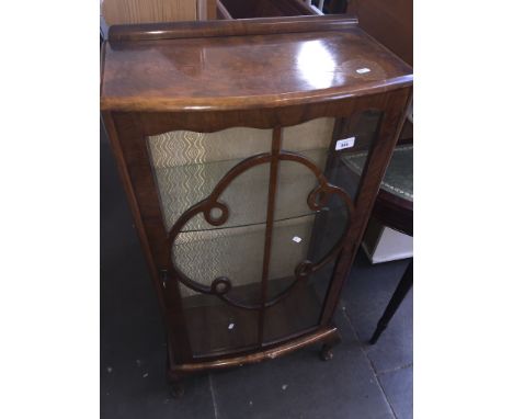 A walnut veneered bow front glazed display cabinet 