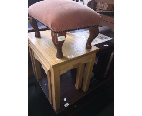 A light wood nest of tables and a foot stool 
