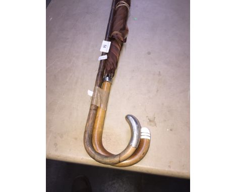 A ladies umbrella with ivory tip and hallmarked silver band, and a hallmarked silver mount bamboo walking stick 