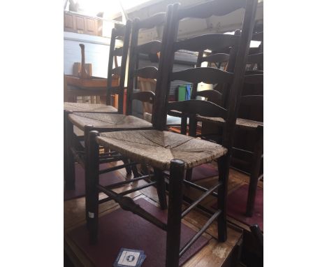 A set of six rush seated ladder back chairs