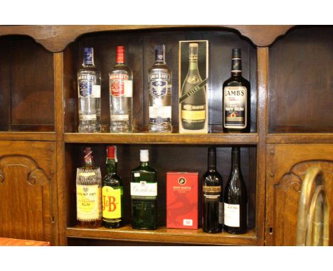 Eleven bottles of various spirits including three Smirnoff, Lambs Navy Rum, Gordons Gin, etc