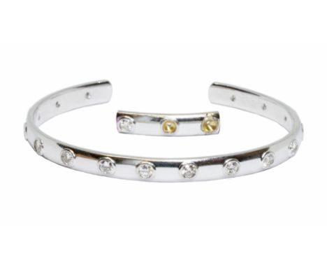 DAVID BURNS: an 18ct white gold diamond bangle, sixteen round brilliant cut diamonds weighing approximately 3cts in total, ha