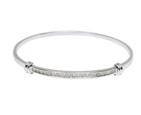 A diamond bangle, twenty round brilliant cut stones weighing approximately 1ct in total, white metal marked '750', diameter a