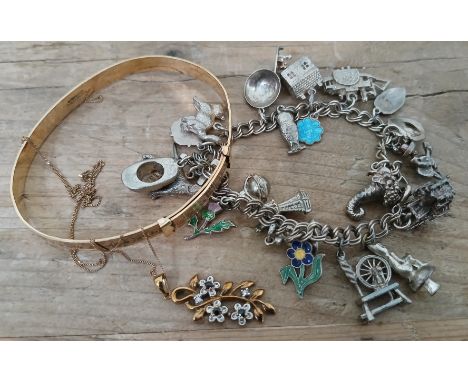 A mixed lot of jewellery comprising a pendant and chain marked '375' weight 2.2g, a rolled gold bangle and a white metal char
