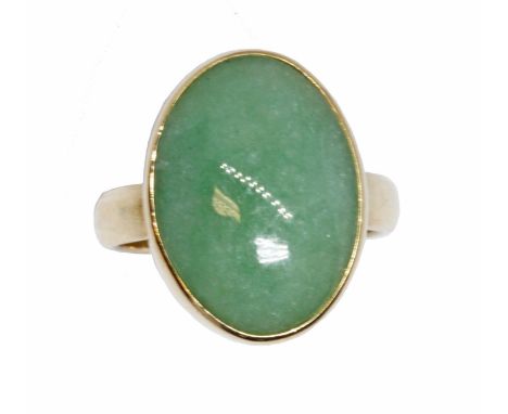 A jadeite jade cabochon ring, the bezel set cabochon measuring approximately 15mm x 6mm, yellow band marked '14K', gross weig