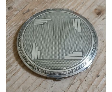 An Art Deco hallmarked silver compact, diameter 8.5cm.